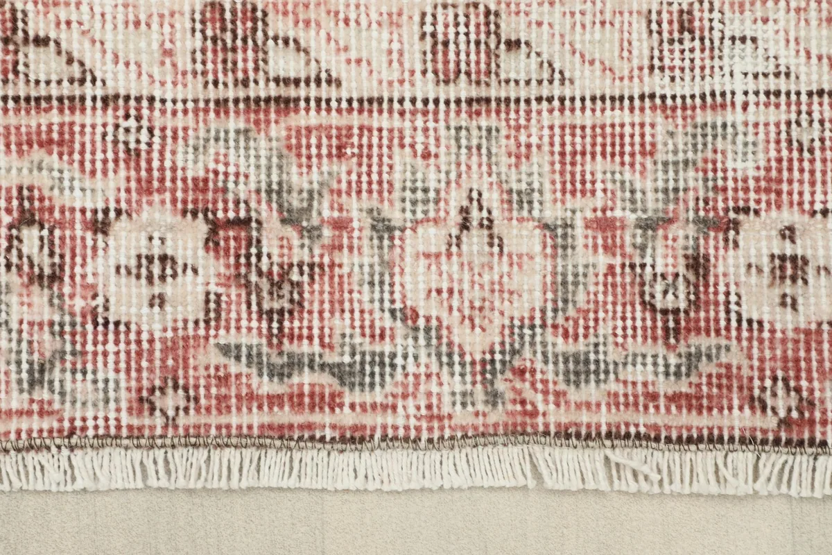 Detailed shot of the rug's border and fringe, showcasing the craftsmanship and colors