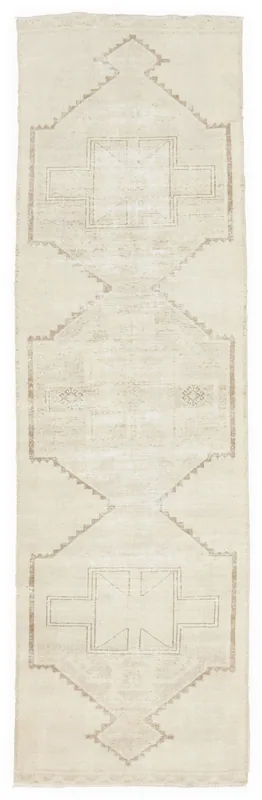 Full overhead view of the vintage Anatolian runner with ivory and tan geometric patterns
