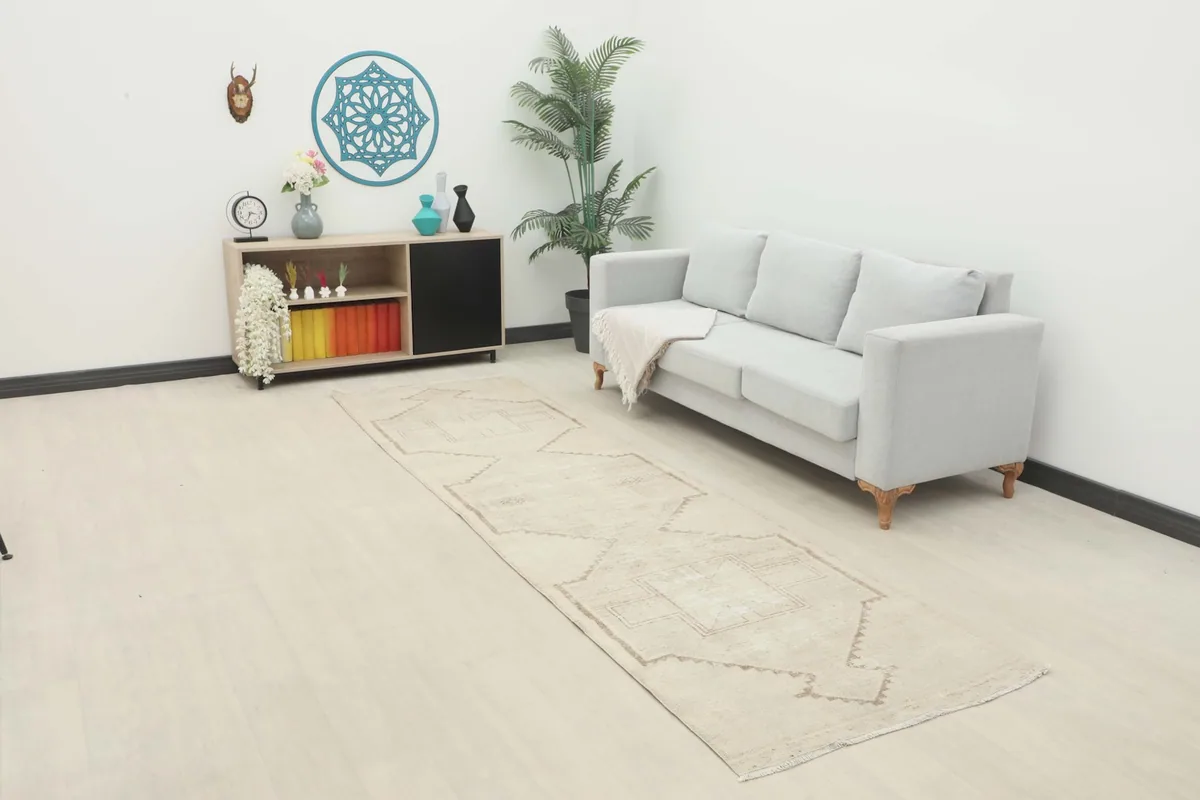 Vintage ivory runner in a living room setting next to a light gray sofa