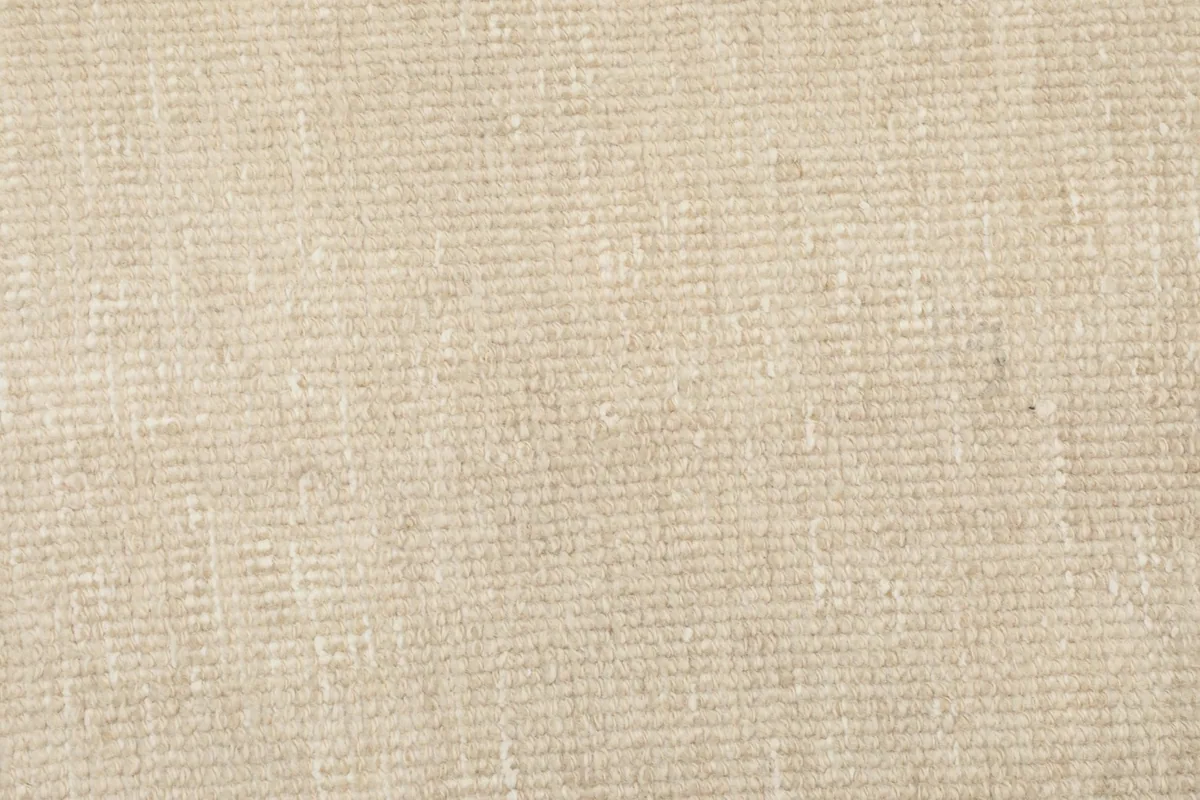 Close-up of the hand-knotted wool pile, showing the tight weave and natural fibers of the rug