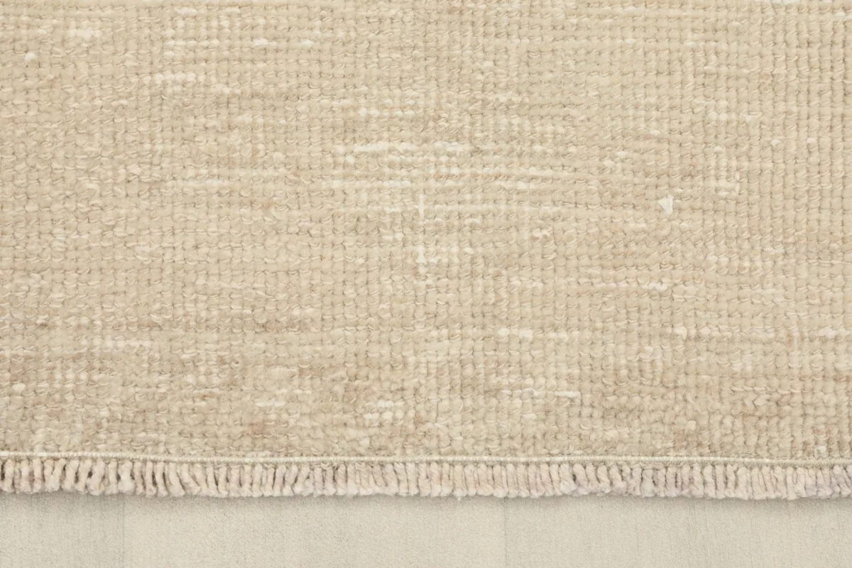 Detail of the short, natural cotton fringe along one end of the vintage cream runner