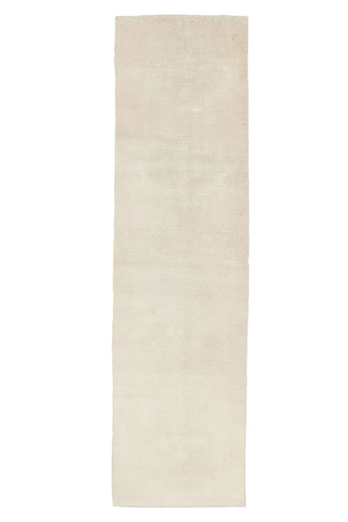 Overhead view of the hand-knotted cream wool runner, showing its elongated shape