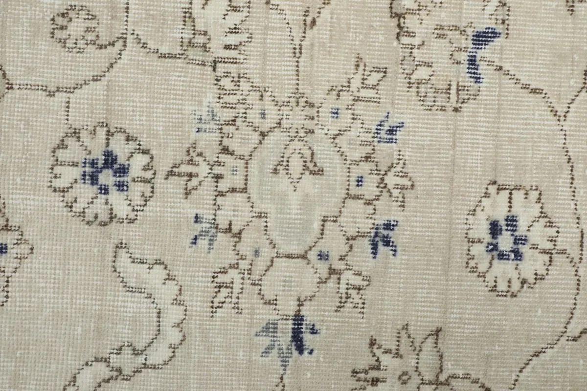Detailed view of a specific floral medallion and surrounding patterns on the rug
