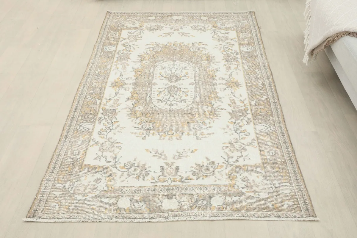 Overhead view of the ivory beige floral rug, showcasing its full design and shape