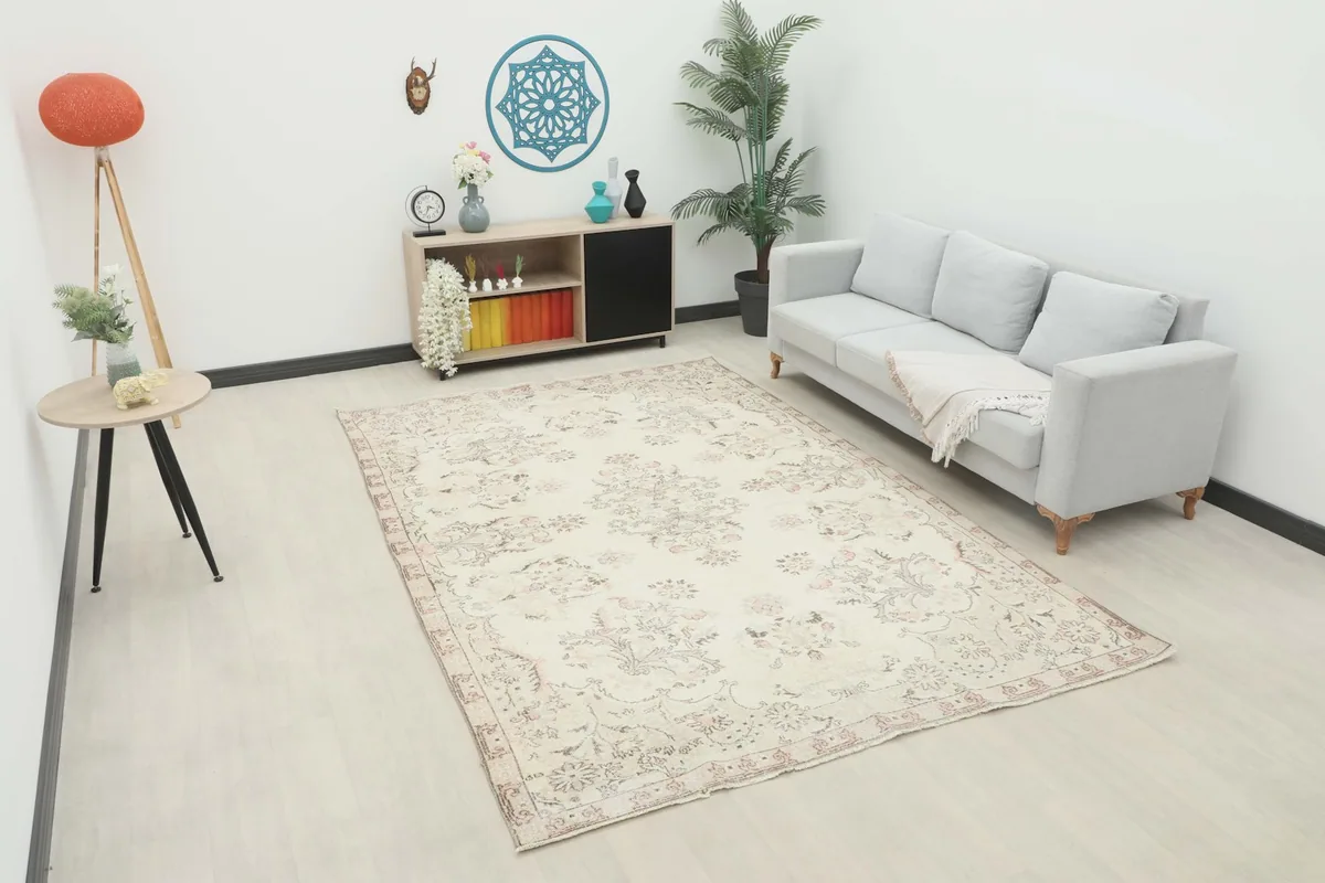 Ivory and rose floral rug displayed in a modern living room setting