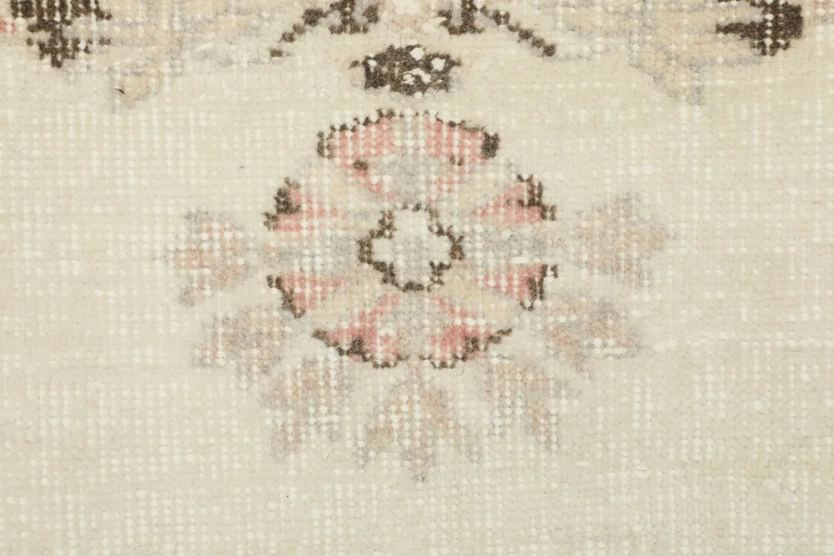 Detailed view of a single rose-colored floral element with gray accents