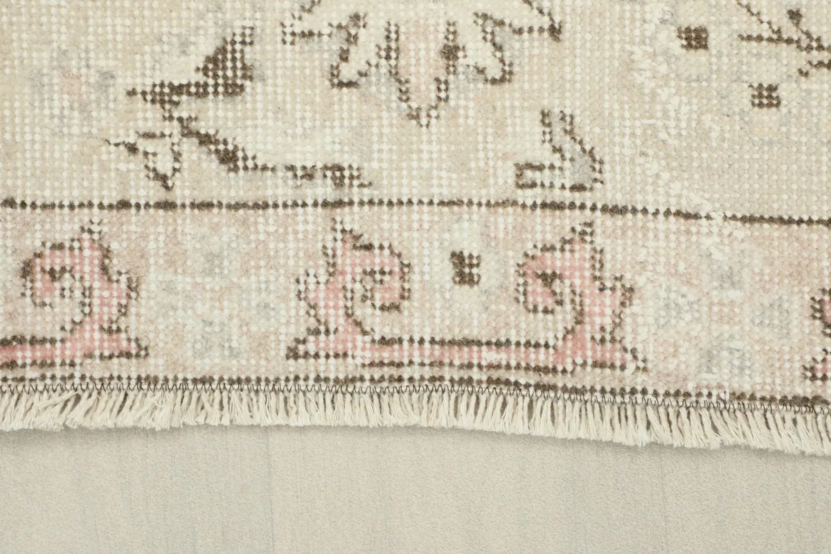 Close-up of the short fringe and the distressed border pattern of the rug