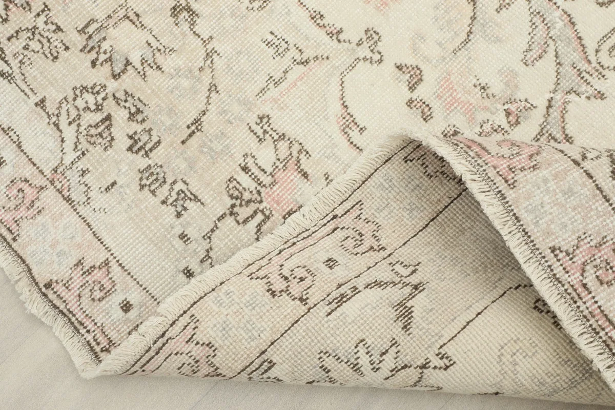 View of the rug folded back, showing the wool pile on cotton foundation