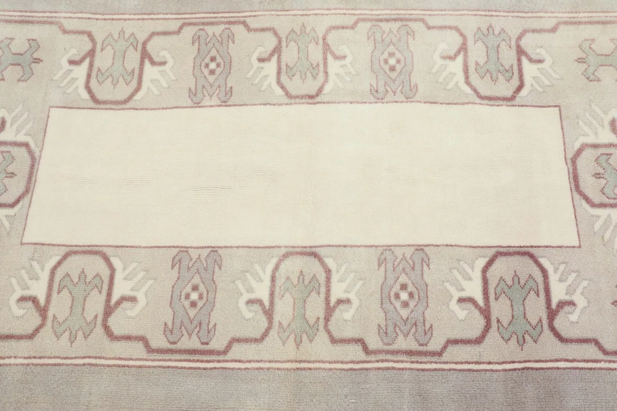 Close-up overhead view of the central ivory panel and surrounding geometric motifs