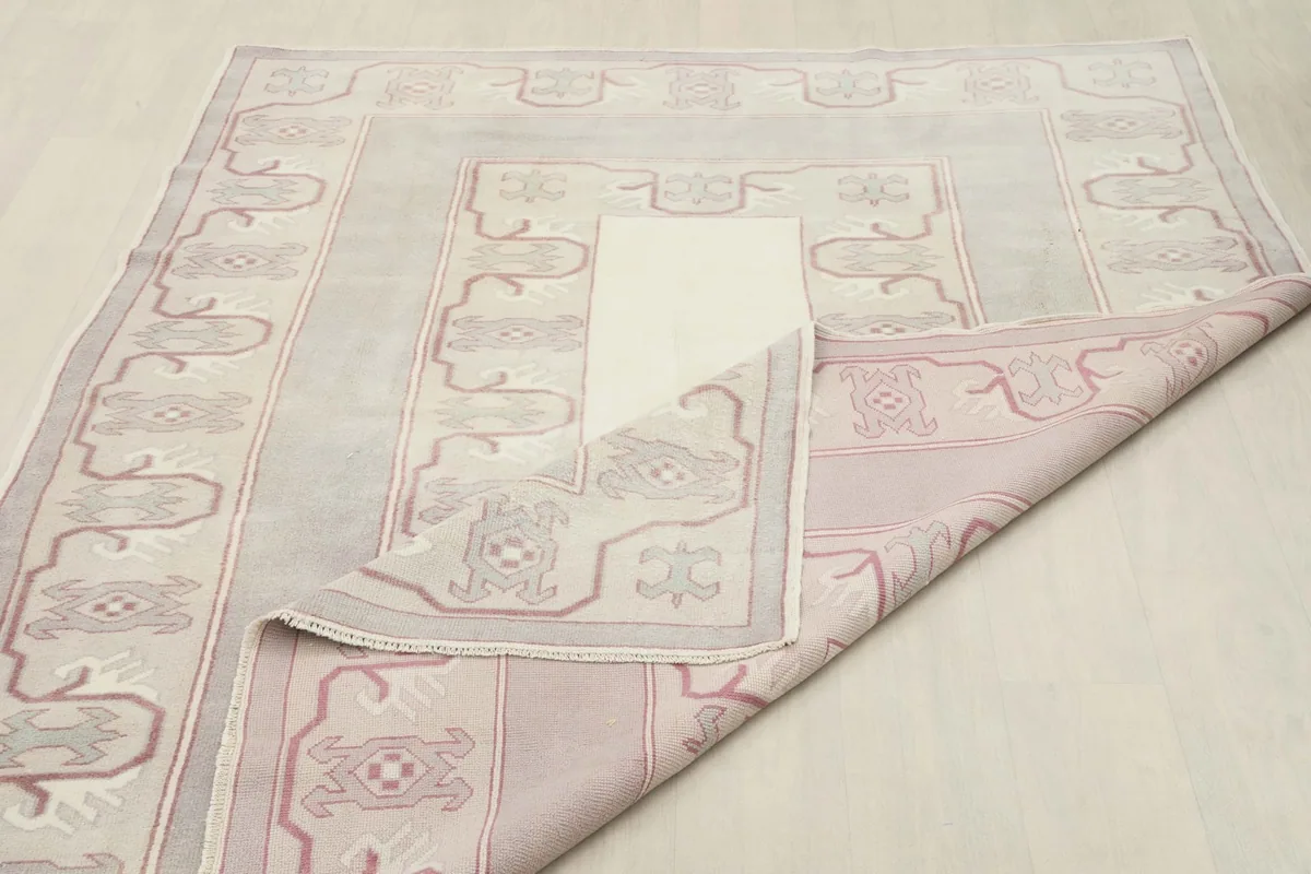 View of the back of the rug, showing its hand-knotted construction and foundation