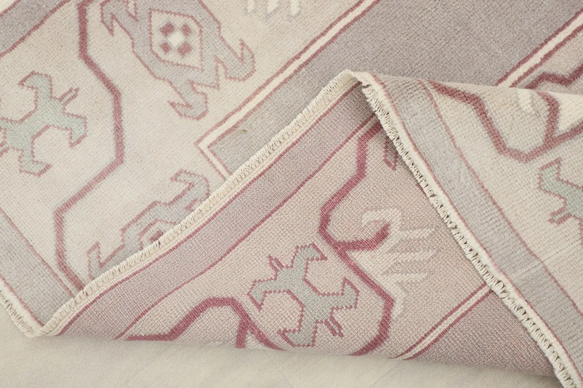 Folded corner of the rug revealing the thickness of the wool pile and cotton foundation