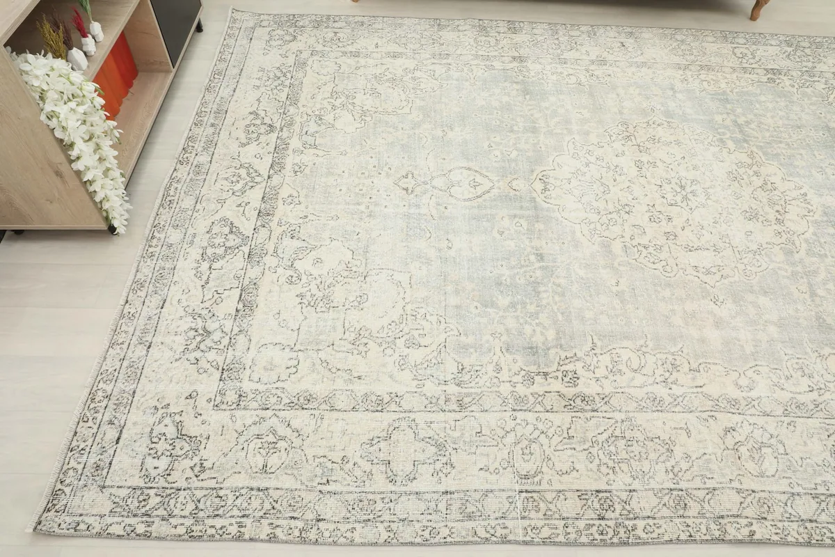 Another angled view of the vintage Anatolian rug, displaying its full size and design in a room.