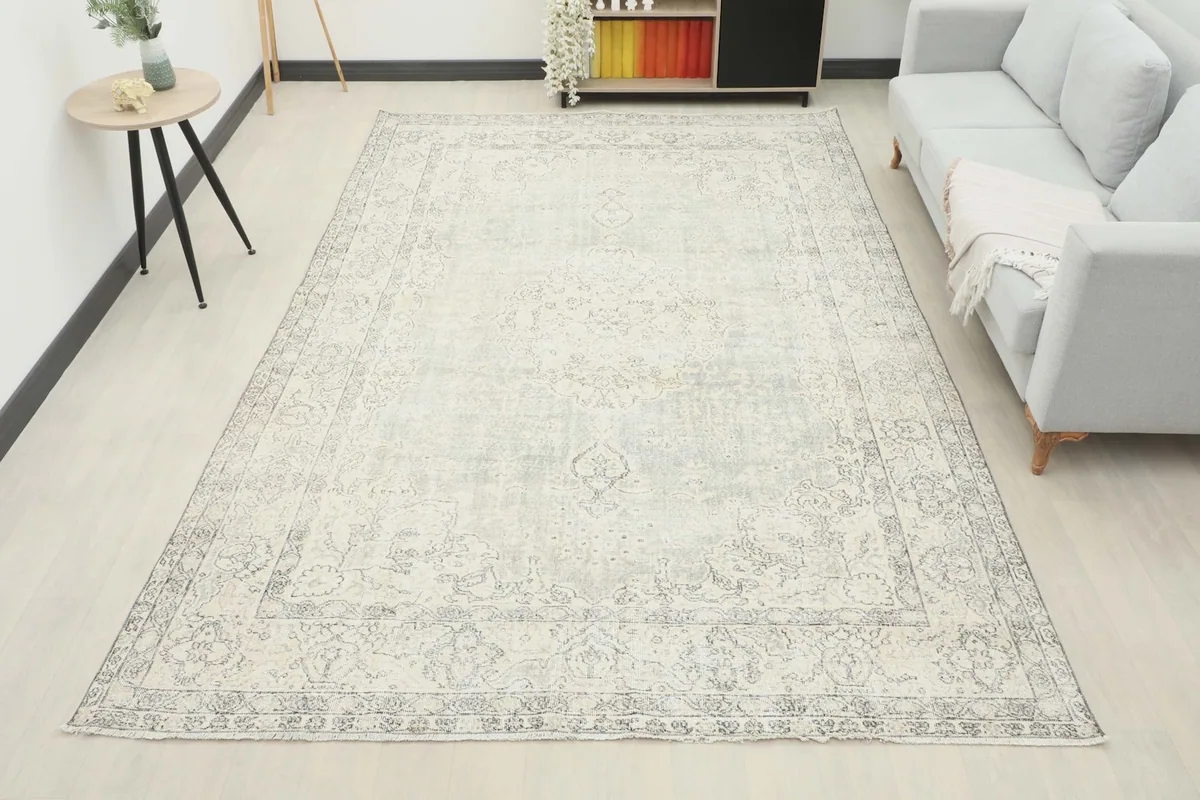 Full room view of the 7'9" x 11'7" cream and gray vintage rug, anchoring the living space.
