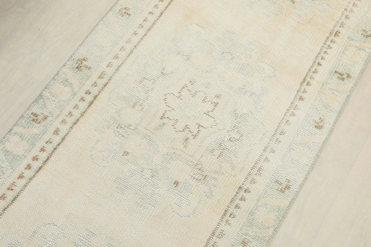 Angled view along the length of the runner, showcasing the repeating geometric motifs and border design.