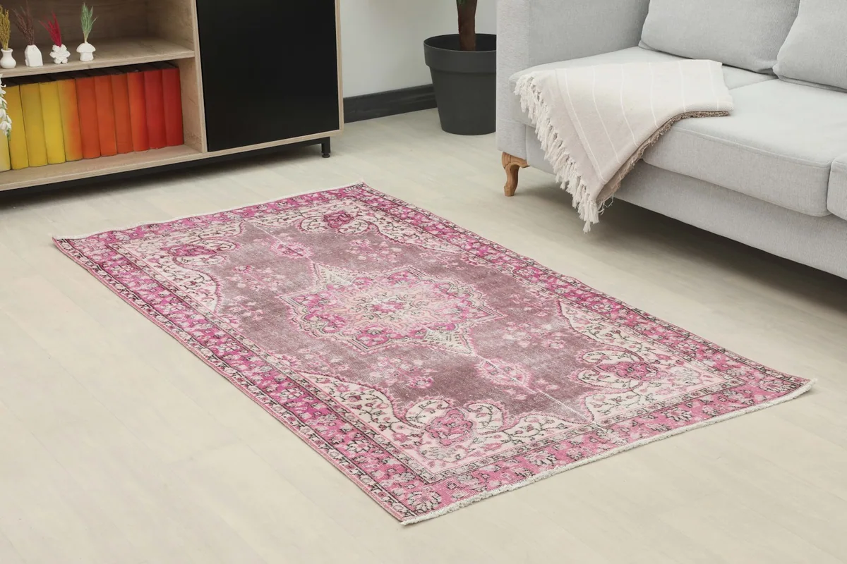 Angle view of the rose and gray vintage rug in a modern living space