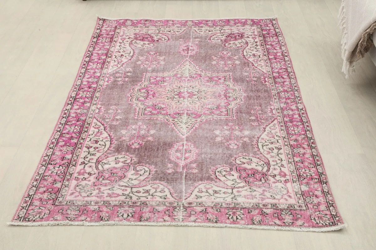 Full overhead view of the rose and gray vintage Anatolian rug from a slight angle