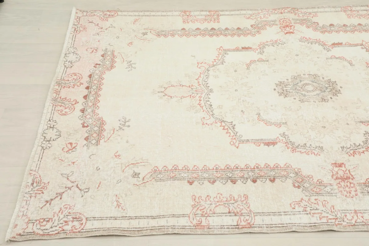 Another angled perspective of the ivory vintage rug, capturing its overall design