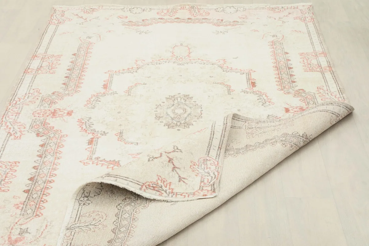 Rug partially folded, illustrating its flexibility and construction