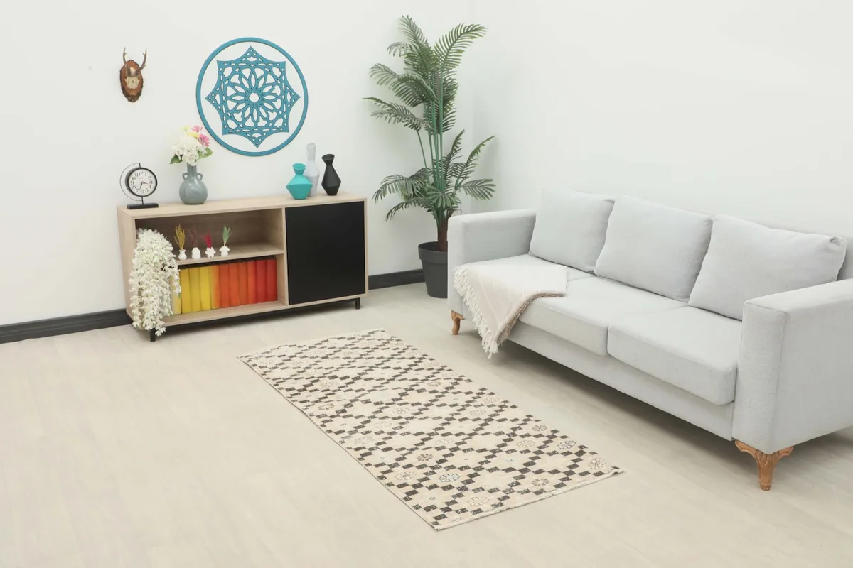 Ivory and charcoal vintage runner rug displayed in a bright living space with a light sofa and wooden console.