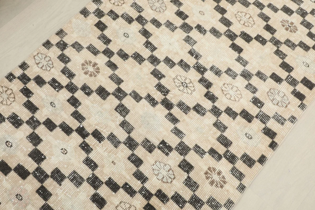 Detailed angled view of the rug's surface, showing the subtle variations in the hand-knotted wool pile.