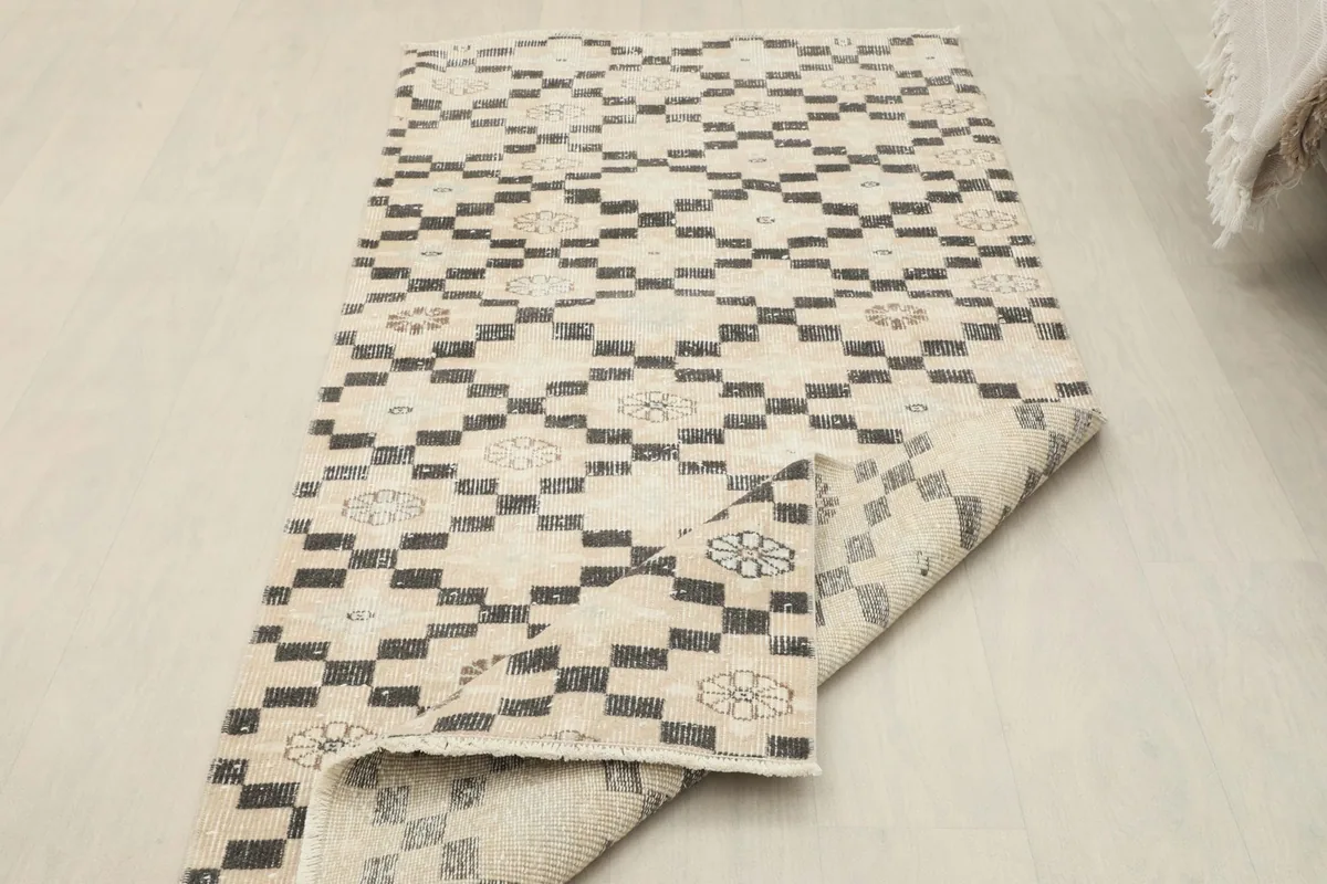 The vintage runner rug folded back to show the reverse side and overall thickness.
