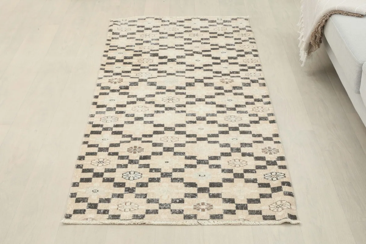 Overhead view of the small vintage runner rug in a room setting, showcasing its full pattern and colors.