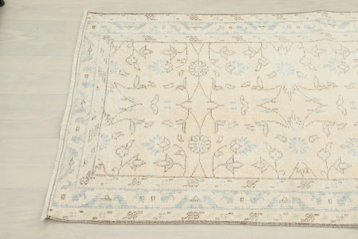 Detailed view of the rug's border design and central patterns from an elevated angle.