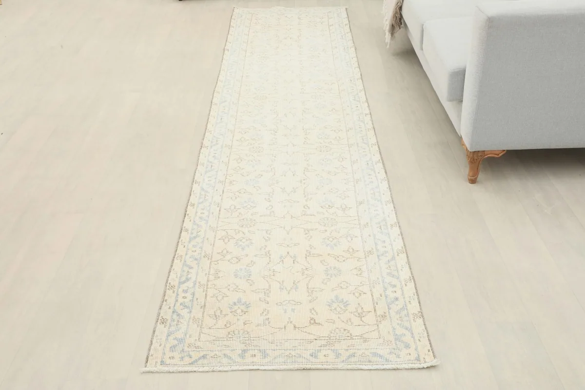 Full overhead view of the vintage Anatolian runner rug laid out in a room, showing its elongated shape.