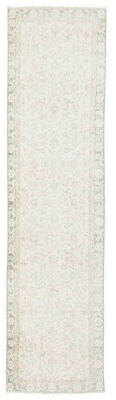 Full overhead view of an ivory and gray floral Anatolian runner rug on a white background.