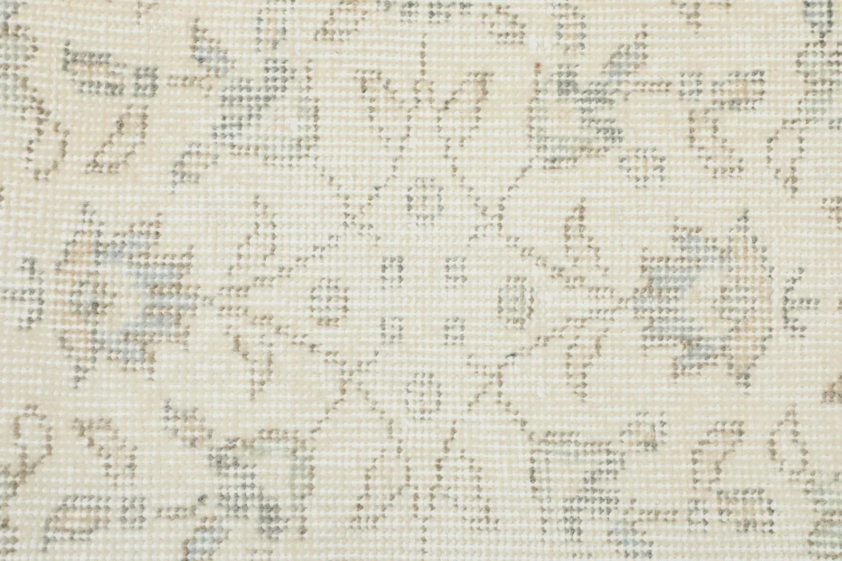 Close-up of the low wool pile, showing the hand-knotted texture and intricate floral design.