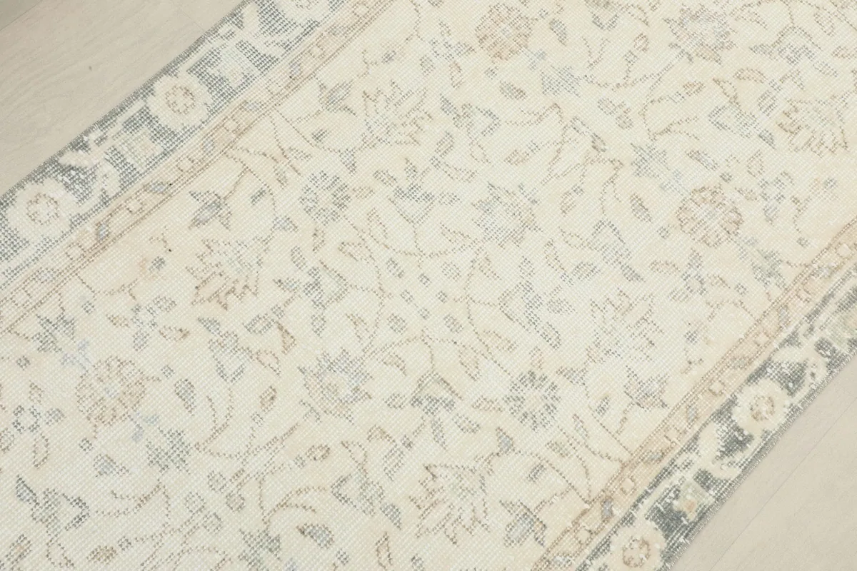 Overhead view focusing on the central part of the runner, highlighting the faded floral patterns and texture.