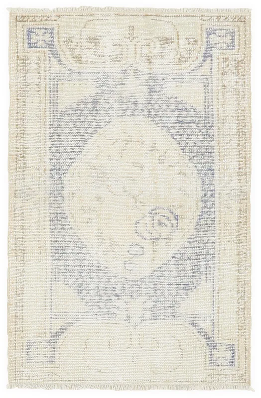 Top view of the 2'8" x 4'5" vintage Anatolian area rug with cream and blue medallion pattern