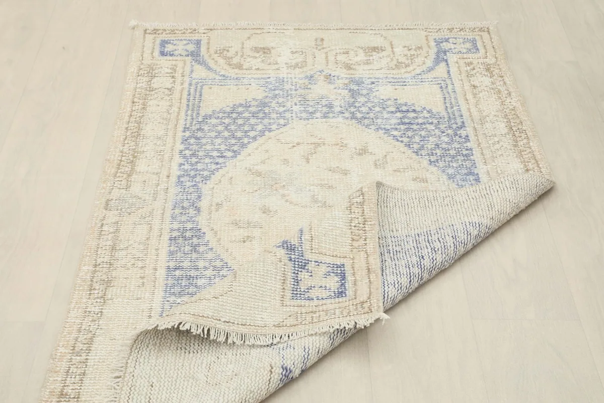 Rug partially folded to reveal the reverse side and construction