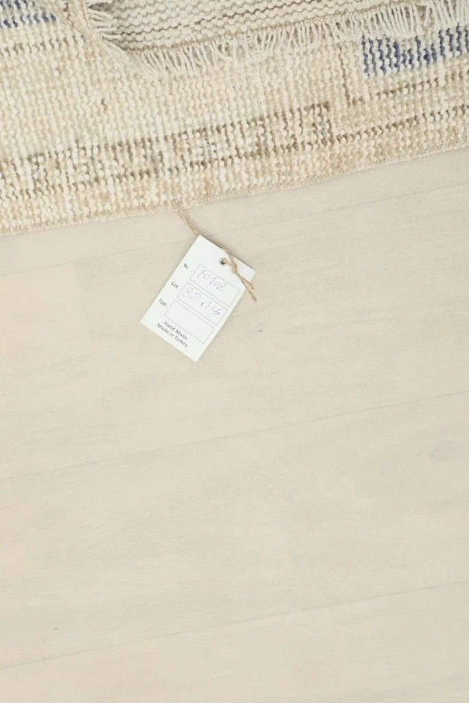 RugsKilim product tag on the floor next to the area rug