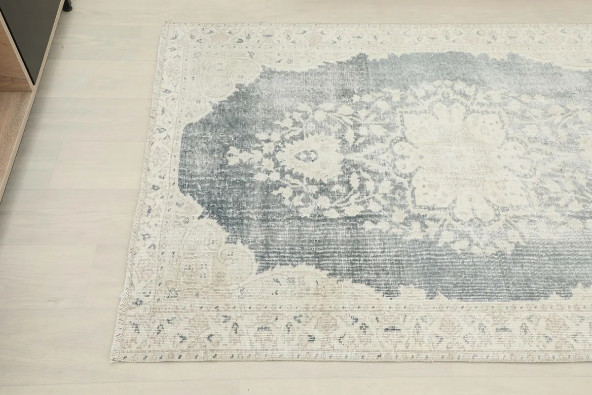 Overhead angle view showing the rug's medallion and floral patterns