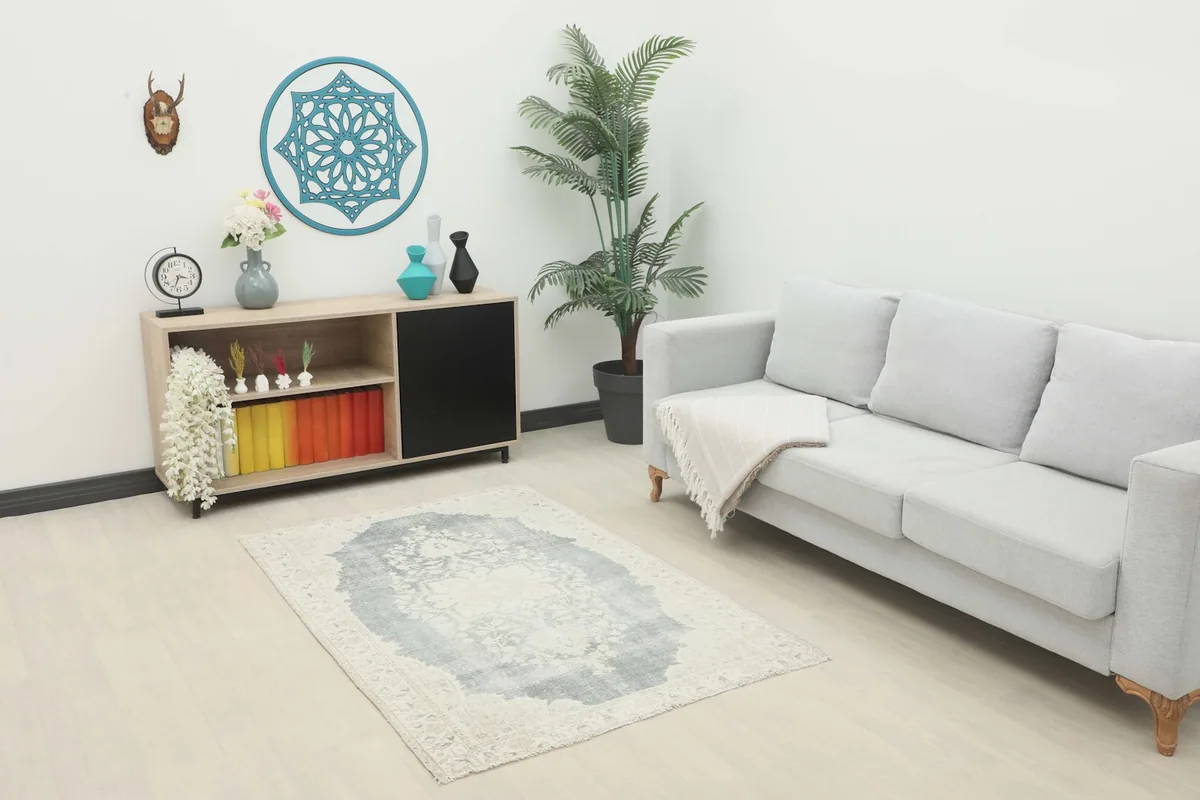 Vintage gray and ivory rug placed in a modern living room setting
