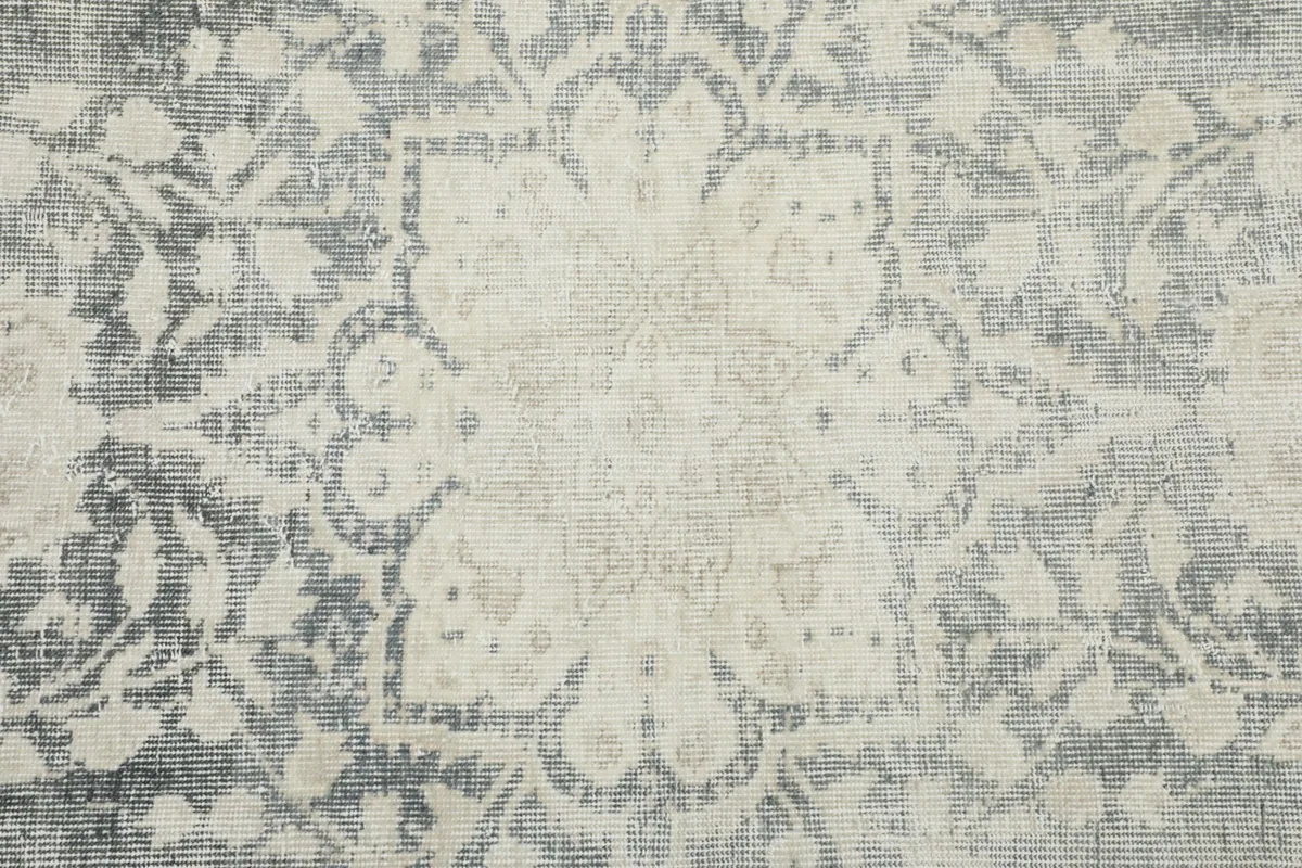 Close-up of the intricate floral and medallion motifs on the rug's surface