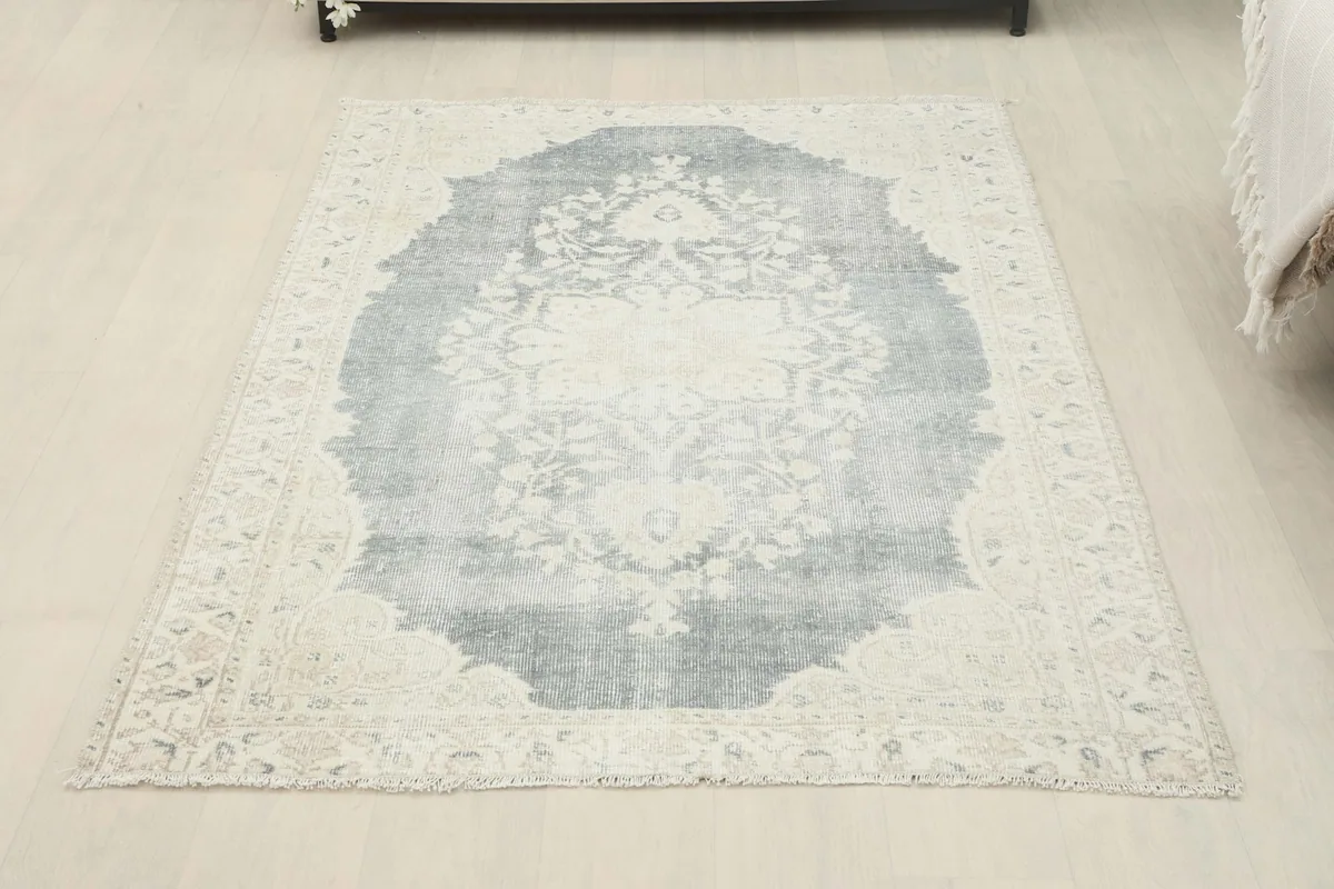 Full overhead view of the gray and ivory rug laid flat on a light floor
