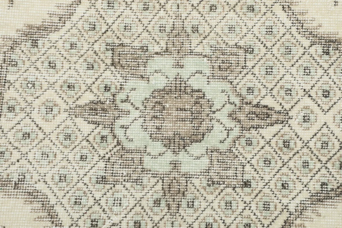 Detailed close-up of the central medallion design with geometric and floral motifs