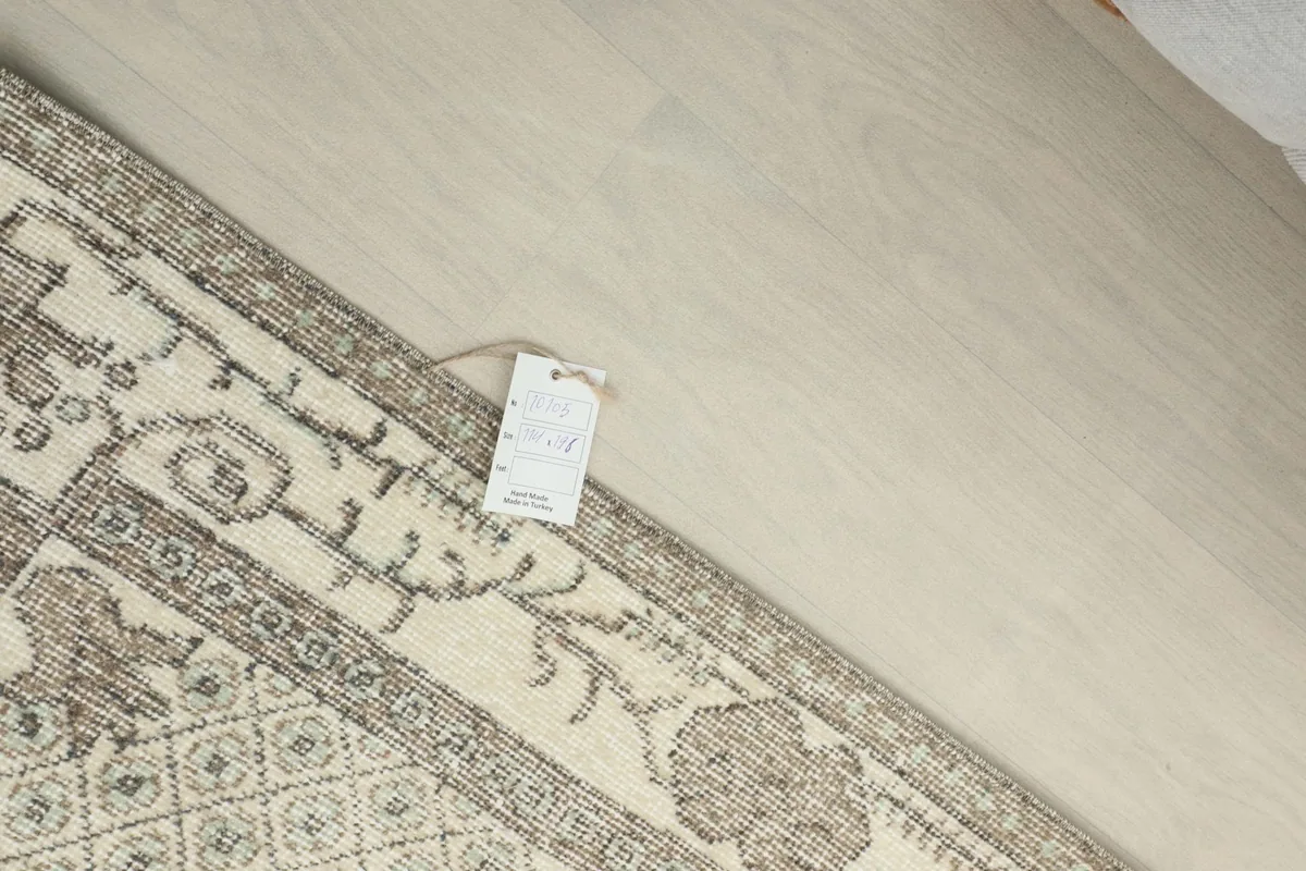 Close-up of the back of the rug, showing the tag and intricate knotting