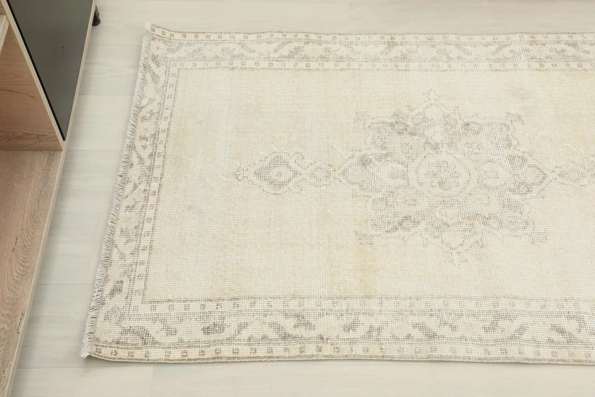Detail view of the rug's border and central motif, showing subtle color variations