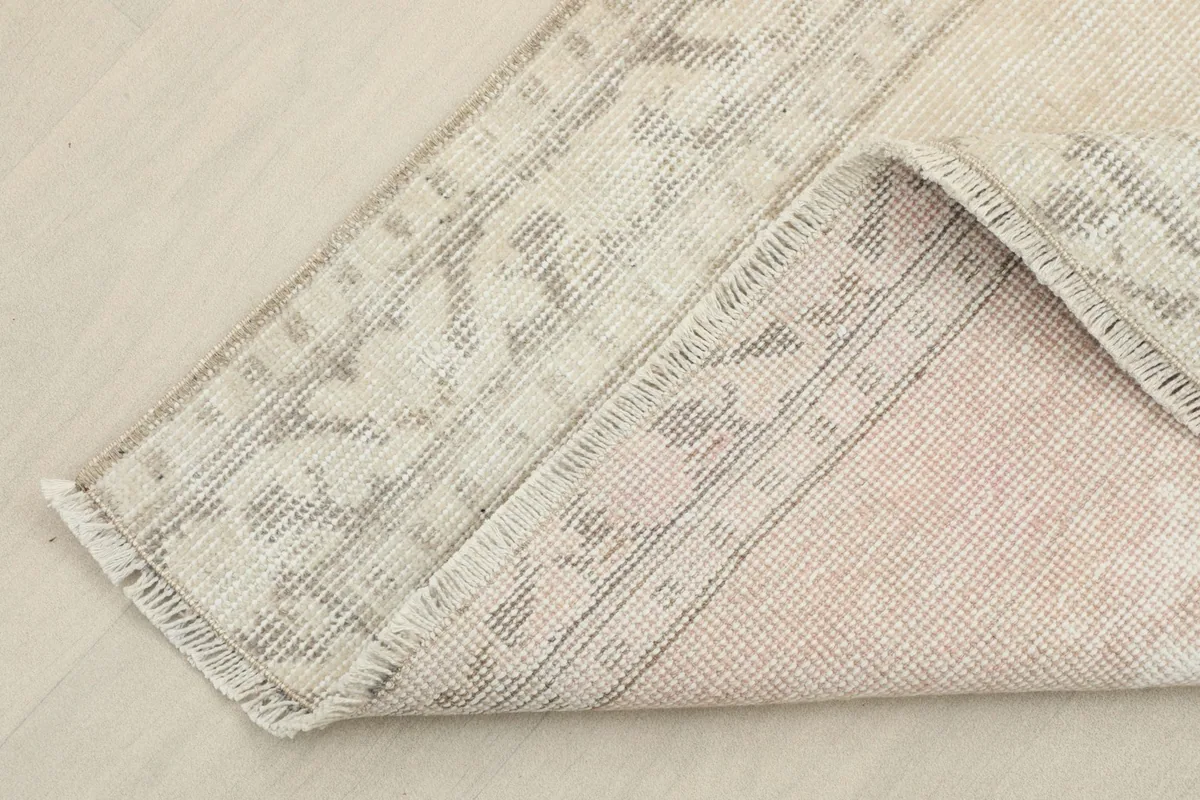Close-up of the hand-knotted cotton foundation and wool pile from the back
