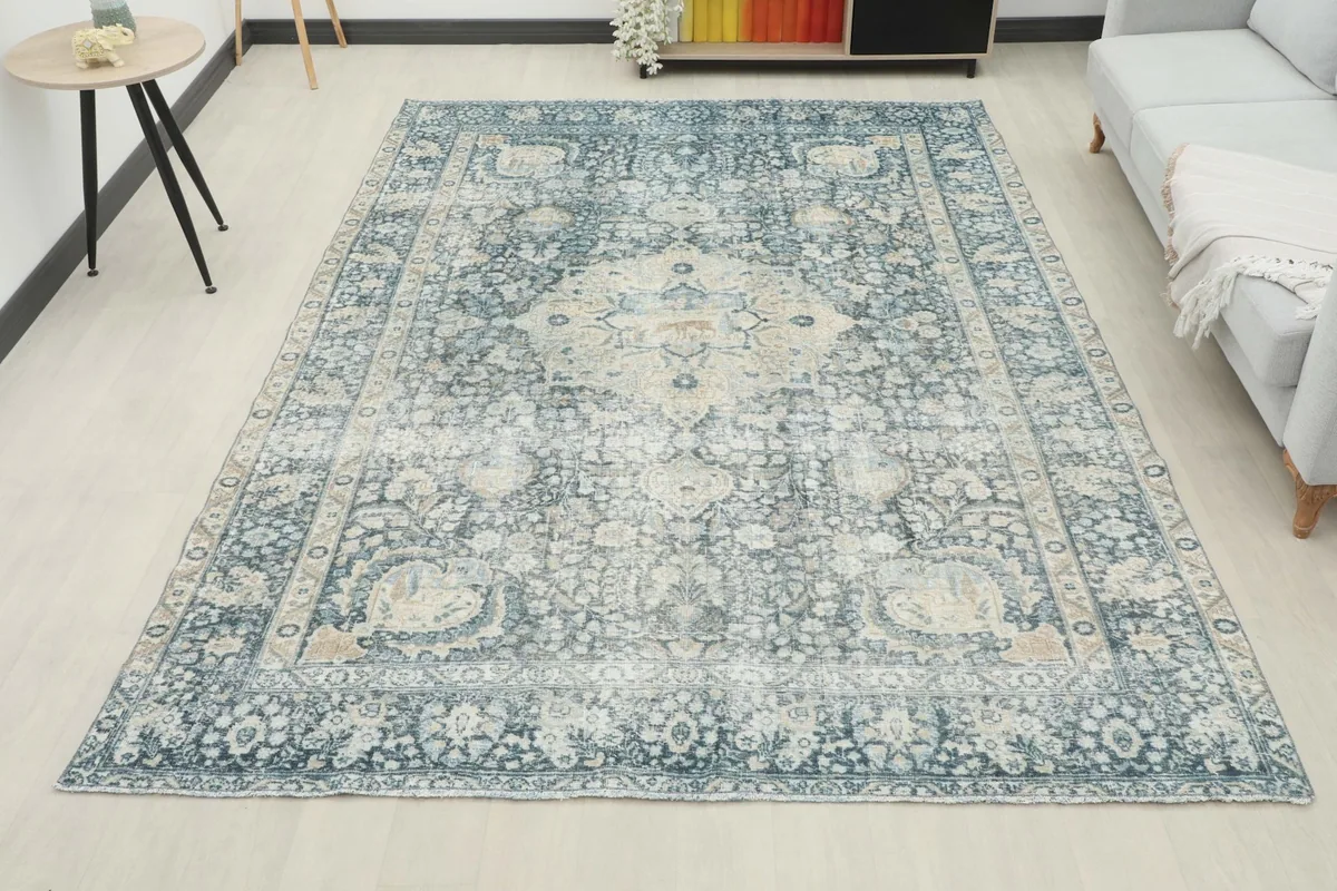 Full room view of the blue and cream vintage rug, showing its scale and impact in a space