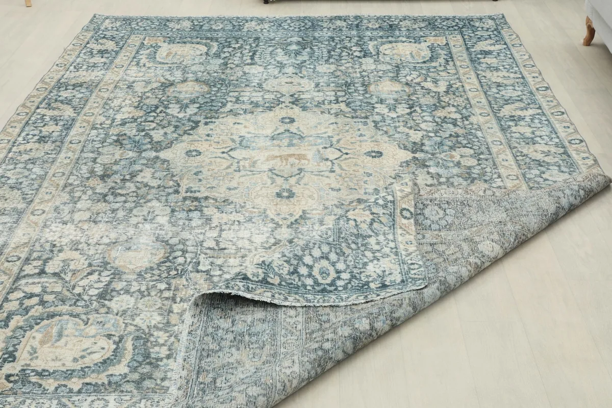 Partial view of the rug's reverse side and pile, demonstrating its hand-knotted structure