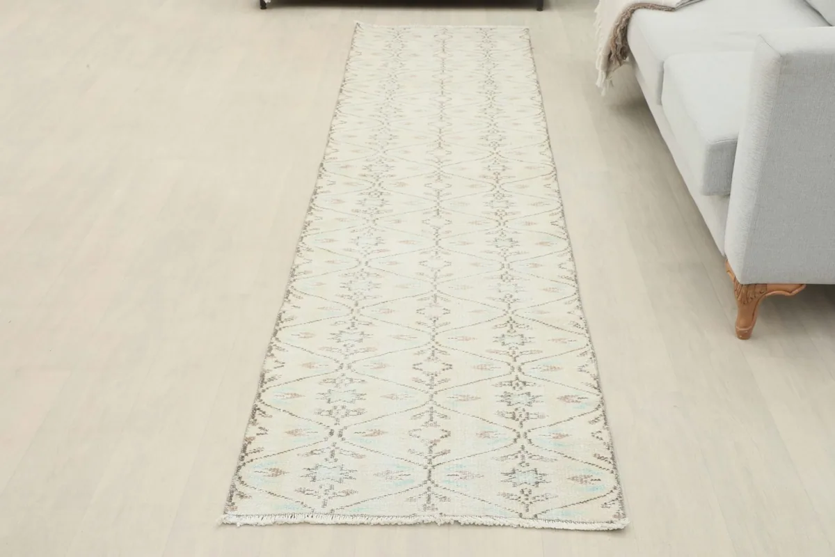 Full room view of the cream geometric runner extending across a light-colored floor.