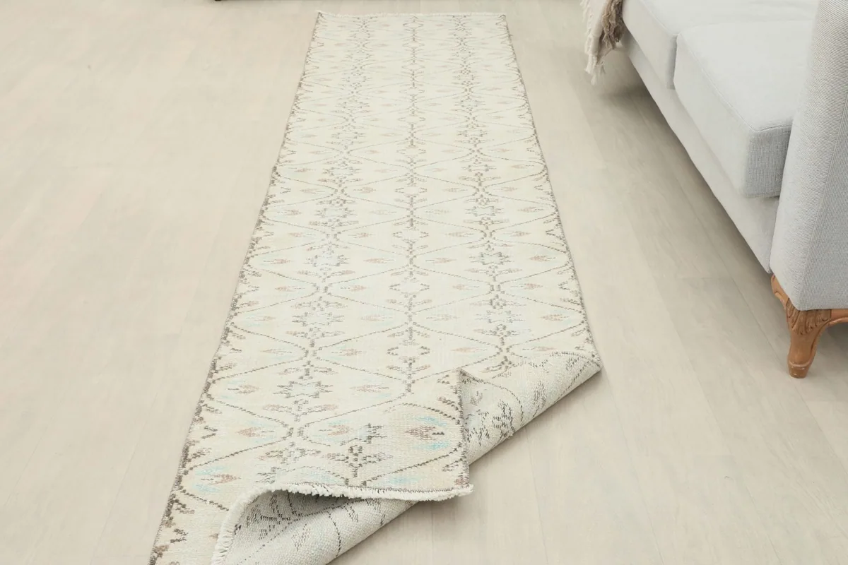The runner partially folded, showing the flexibility and texture of the vintage wool.