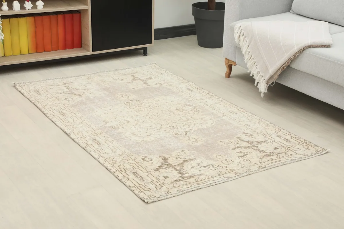 Angle view of the rug in a living room setting, showcasing its size and colors next to a sofa