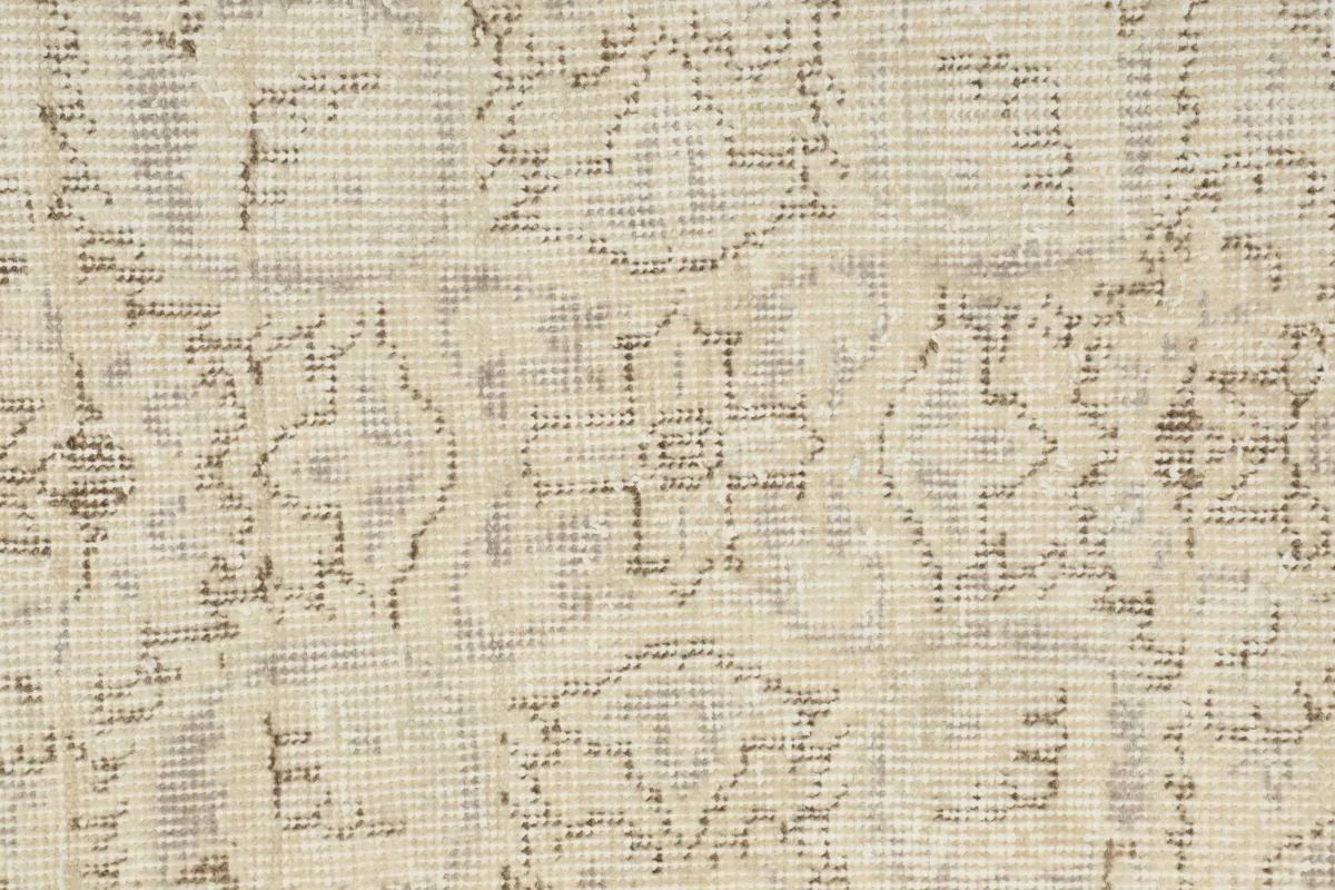 Detailed close-up of the rug's pattern, showing individual knots and areas of wear in the pile