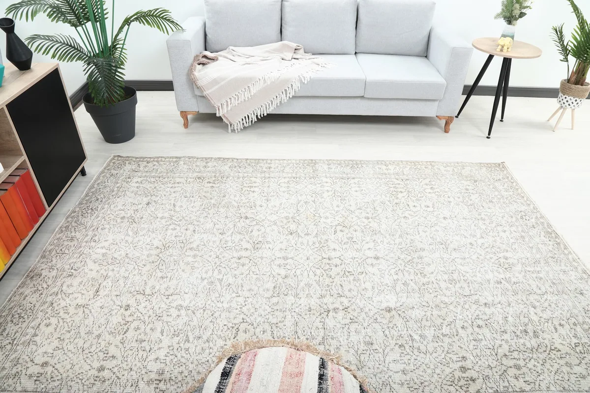 Overhead view of the rug in a room, highlighting its placement relative to the sofa and ottoman