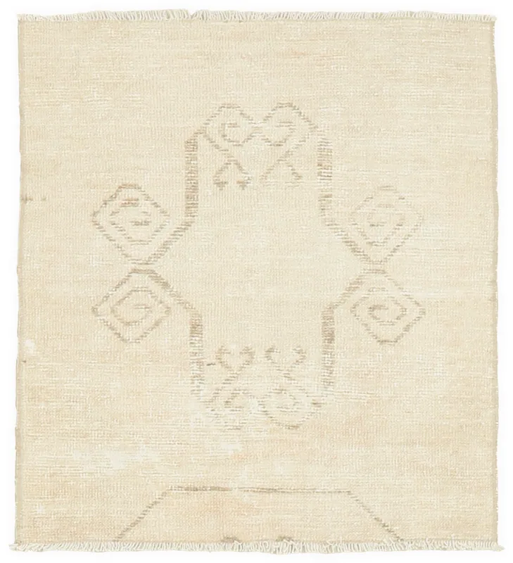 Full overhead view of the ivory and tan geometric vintage Anatolian wool rug